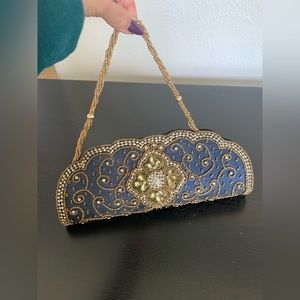 Never used ethnic clutch/purse in navy blue with gold embellishments.